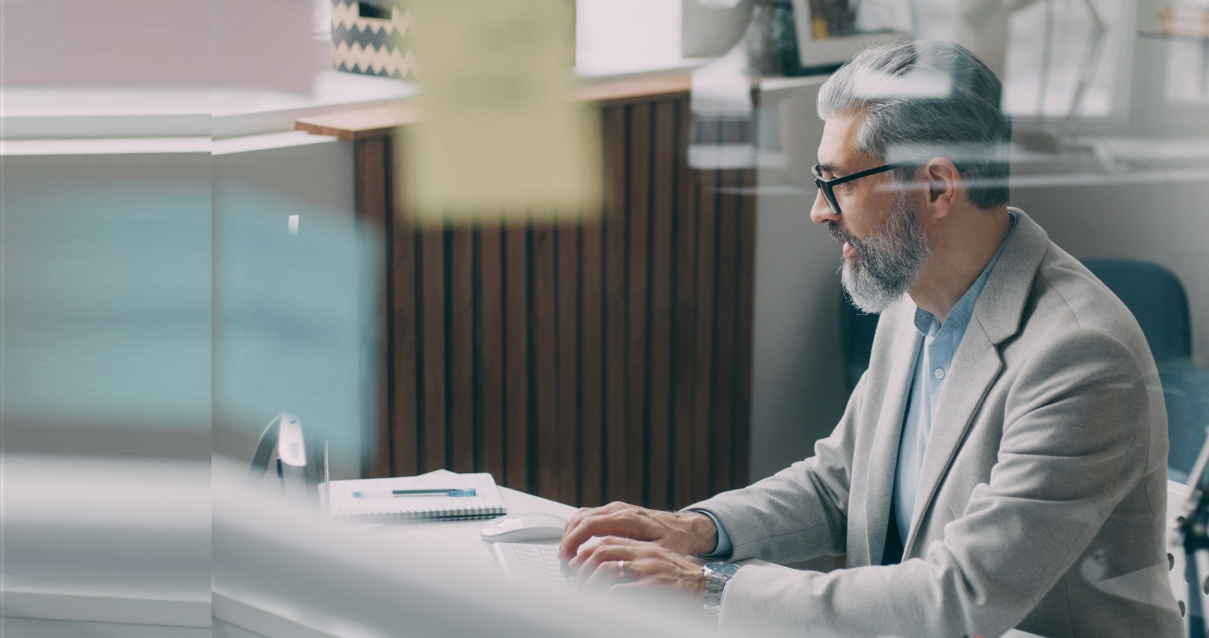 Business owner working at his desk in a bright office